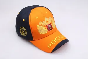 Detailed golden double-headed eagle embroidery on a two-tone orange and navy baseball cap