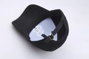 Detail view showing internal structure and silver metal buckle of black hip-hop cap