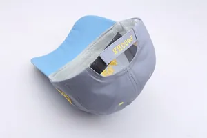 Detail of adjustable strap with yellow Russia embroidery on a grey baseball cap