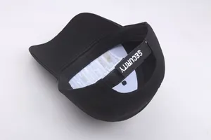 Detail of adjustable velcro strap with white SECURITY embroidery on black baseball cap
