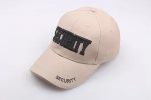 Detailed view of bold black SECURITY embroidery on a khaki cotton baseball cap