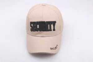 Detail shot of the black SECURITY embroidery on a beige cotton baseball sun hat