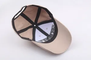 Detail view of cotton baseball cap interior featuring adjustable strap and security embroidery