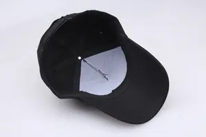 Internal structure of black cotton baseball cap showing white lining and stitching details