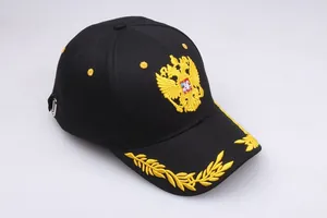 Detailed golden double-headed eagle and olive branch embroidery on black cotton baseball cap
