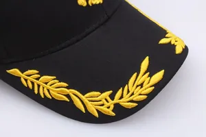 Black baseball cap with golden laurel leaf embroidery in military style on white background