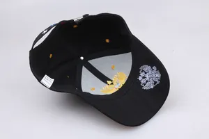 Detailed close-up of the internal structure and 100% cotton label on the black baseball cap