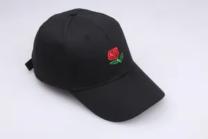 Black cotton baseball cap with red rose embroidery on front in a 45-degree angle view