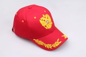 Detailed yellow double-headed eagle embroidery on a classic red cotton baseball cap