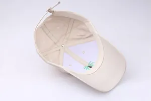 Detail view of cotton baseball cap interior with palm tree embroidery and stitching