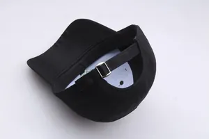 Detail of black baseball cap back with adjustable silver metal buckle and reinforced stitching