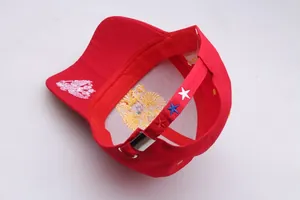 Detail of red baseball cap with white eagle embroidery and Russian flag star on back