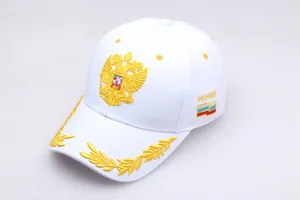 Close-up of golden Russian double-headed eagle embroidery on white baseball cap
