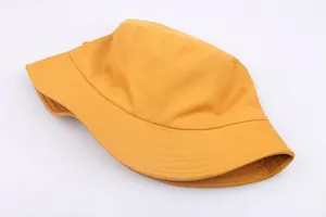 Unisex yellow bucket hat in minimalist cotton design with reinforced stitching for outdoor