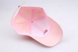 Detail of pink baseball cap interior showing rose embroidery stitching and metal buckle