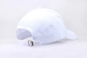 Detailed back view of white cotton baseball cap showing adjustable strap and brass buckle