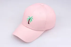 Detail of green palm tree embroidery on light pink cotton twill baseball cap