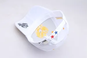 Detail of white baseball cap showing metal buckle, star embroidery, and double-headed eagle