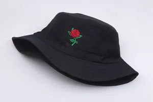 Detailed view of red rose embroidery on a black cotton twill bucket hat for women