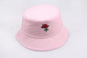 Detailed close-up of red rose embroidery on a pink cotton bucket hat for women