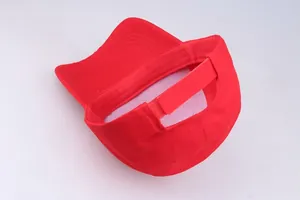 Detail view of red cotton baseball cap with adjustable hook-and-loop strap closure