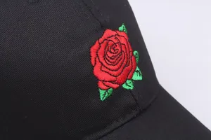 Black cotton baseball cap with red rose embroidery shown in a front view perspective