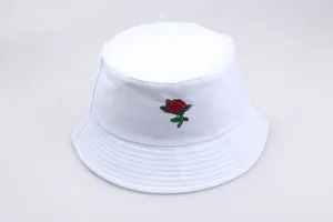 Close-up of red rose flower embroidery on a white cotton canvas bucket sun hat