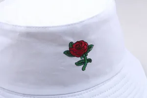 Close-up of red rose flower embroidery on a white cotton twill bucket hat