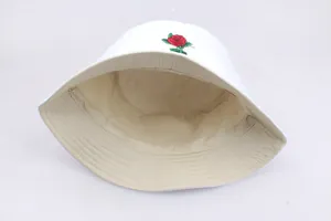 Close-up of red rose embroidery and reinforced stitching on a white cotton bucket hat
