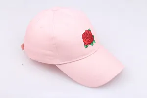 Close-up of red rose embroidery on pink cotton baseball cap with high density stitching