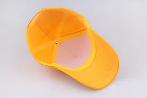 Internal view of yellow baseball cap showing reinforced seams and white inner lining