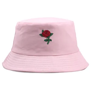 Pink cotton bucket hat for women featuring a red rose embroidery on a white background