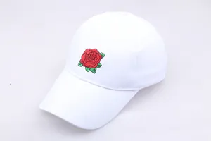 Close-up of high-quality red rose flower embroidery on a white cotton baseball cap