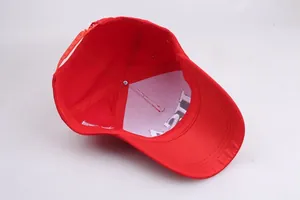 Detail of red baseball cap interior with USA embroidery and adjustable plastic snap closure