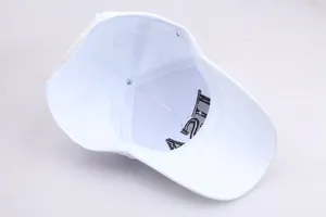 Detailed interior of a white cotton baseball cap showing internal seams and embroidery