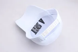 Detail of adjustable snapback closure and USA embroidery on white baseball cap