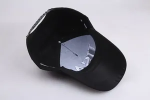 Detail view of the black cotton baseball cap interior featuring adjustable plastic buckle