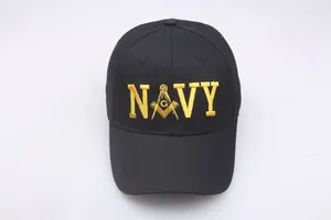 Detail of yellow NAVY embroidery and Freemason symbol on a black cotton baseball cap