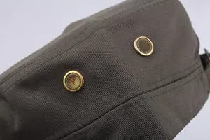 Detail of grey cotton cadet hat featuring metal ventilation eyelets and fabric texture