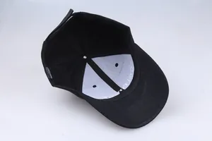 Inside view of black cotton baseball cap showing lining, stitching and wash label details