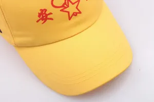 Close-up of safety yellow baseball cap featuring red star and An character embroidery