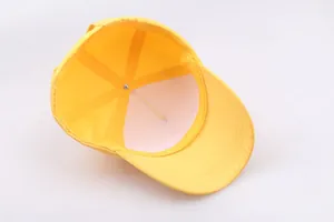 Internal structure of yellow school baseball cap showing 6-panel stitching and inner lining
