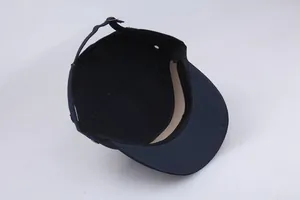 Internal detail of navy cotton cadet cap showing adjustable metal buckle and inner sweatband