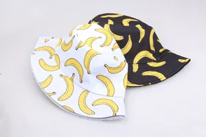 Reversible bucket hat with yellow banana print in black and white cotton fabric
