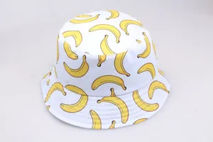 Reversible bucket hat featuring vibrant yellow banana prints on white cotton fabric