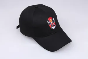 Close-up of traditional Chinese opera mask embroidery on a black cotton baseball cap