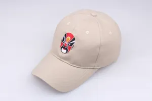 Close-up of traditional Peking Opera face mask embroidery on a khaki cotton baseball cap