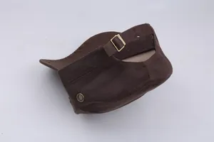 Detail of adjustable metal buckle and breathable eyelets on dark brown cotton army cap