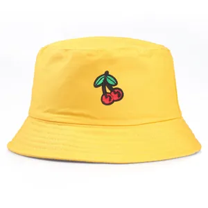 Bright yellow cotton bucket hat with red cherry embroidery and reinforced brim details