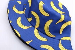 Detail shot of blue reversible bucket hat with banana print and reinforced stitching